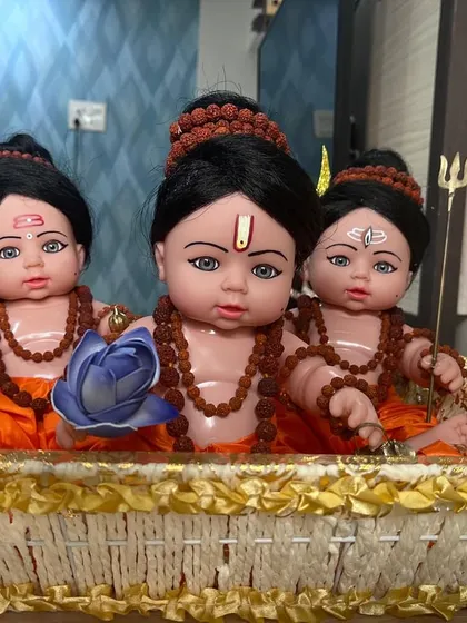 A wider view of the handcrafted Guru Dev Datta dolls, nestled in a decorative basket. We take pride in creating these unique, custom devotional pieces.