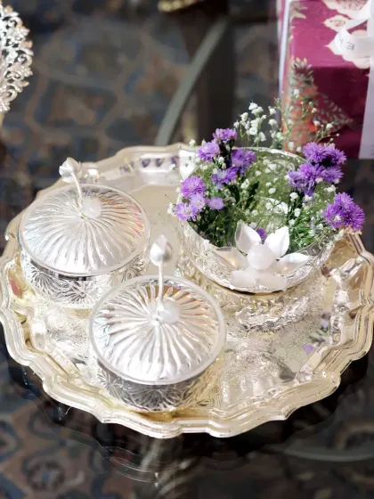 A statement of sophistication. This handcrafted silver tray, shown here holding a floral arrangement, is a versatile piece perfect for festive gifting or as an elegant decor accent in your home.