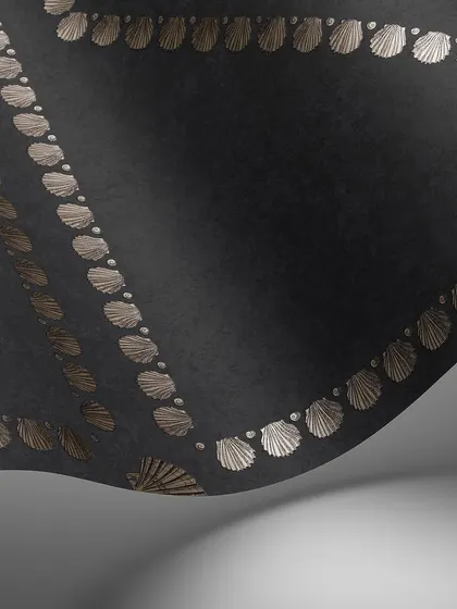 A close-up of the 'Conchiglie' wallpaper in a dramatic black and bronze colorway. The metallic finish on the shells creates a subtle shimmer, adding depth and luxury to the geometric pattern.