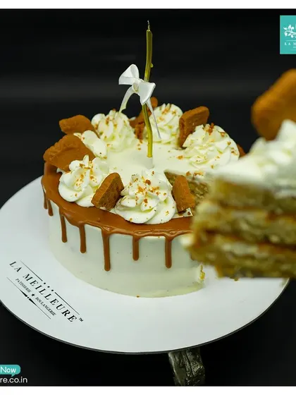 A slice of heaven is waiting. This image captures a perfect slice being taken from my Lotus Biscoff cake, revealing the delicious layers inside.