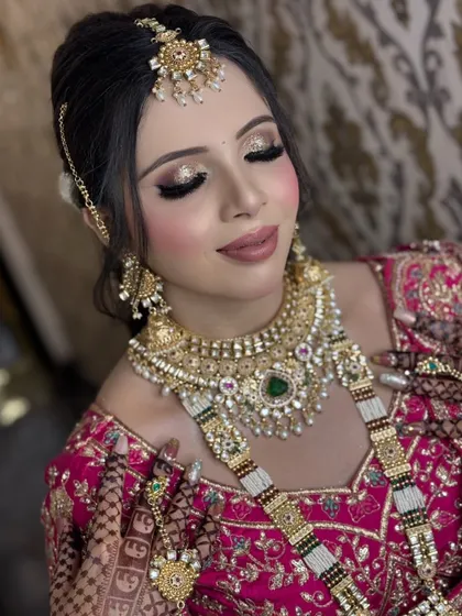 A close-up of a regal bridal makeup look. Notice the detailed golden glitter on the eyelids, the perfectly blended skin, and the way the makeup complements the heavy Polki jewellery. This is the level of detail and precision I bring to every client.