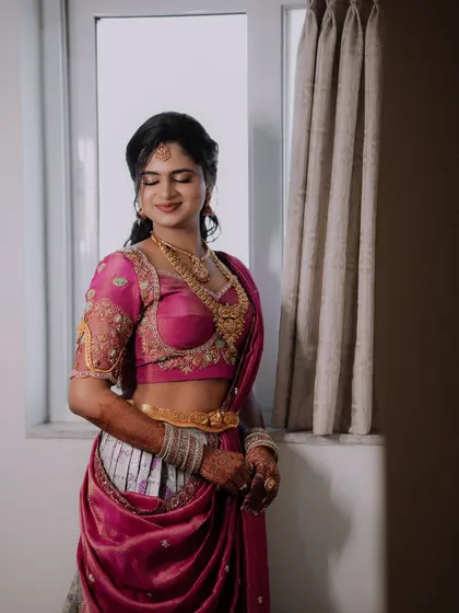 A close-up shot showing the intricate embroidery on the blouse and the beautiful drape of the Langa Dhawani.