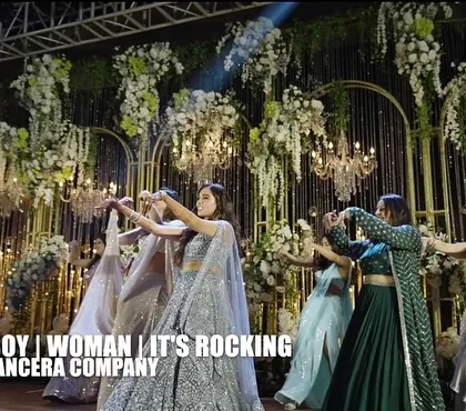 A stunning shot of the bride and her bridesmaids, with dramatic smoke effects adding to the music video vibe of their performance.