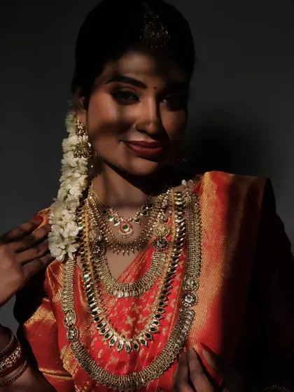 An artistic shot with shadows falling on the bride's face, creating a dramatic and beautiful effect that highlights her features and the makeup.