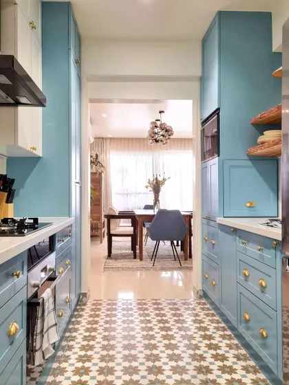 This is the view from the newly integrated utility area back towards the dining room. The open sightline makes the entire apartment feel more connected and spacious, and the beautiful kitchen is now a central feature of the home.