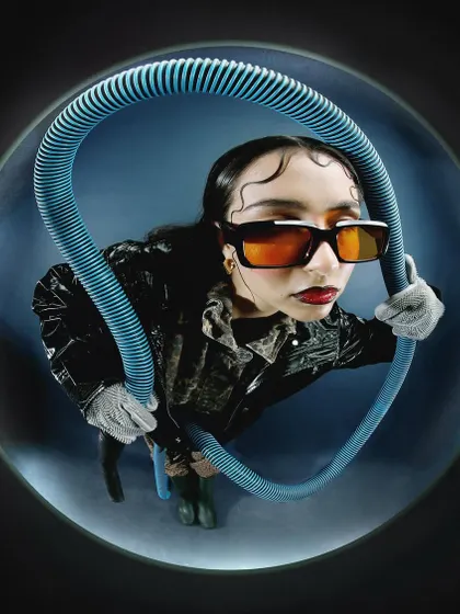 Another take from the fisheye series with the blue tube, this time with the model in a dynamic, leaning pose. The image feels energetic and experimental.