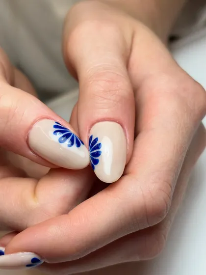 A detailed shot of the cobalt blue floral art. The simple, graphic style of the flower gives it a modern, artistic feel.