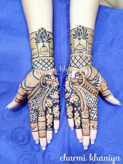 A lovely design combining peacocks and floral patterns. The dark, bold henna work makes the intricate details pop, perfect for a sangeet or wedding reception.