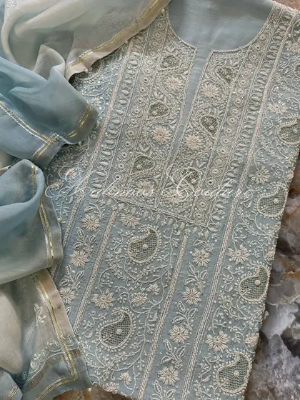 A flat-lay of the suit on a marble background, emphasizing its luxurious quality.