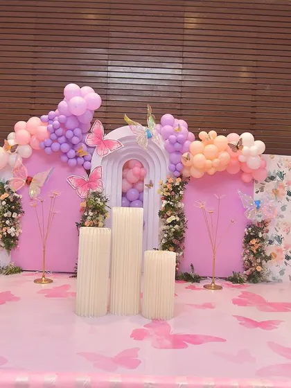 The full view of this grand butterfly decoration, showing the floral arrangements, multiple panels, and a custom-printed floor that ties everything together.