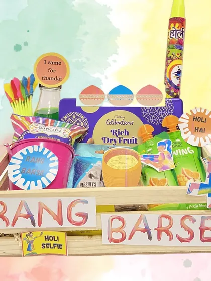 Celebrate Holi with our vibrant 'Rang Barse' hamper. This wooden crate is packed with thandai, organic colors, water guns, and lots of festive snacks.