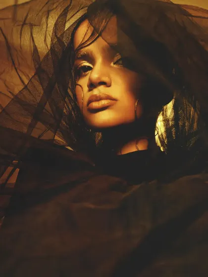 A hauntingly beautiful portrait with a sheer veil, where the golden makeup on the eyes and skin creates a captivating focal point.