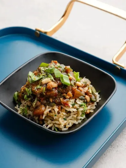 Plated on a modern blue tray, our Veg Loco Moco is a complete meal in a bowl. The combination of rice, a savoury patty, and rich gravy is both delicious and visually appealing.
