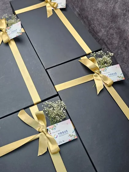 The final presentation for the Vogue Fashion Institute hampers. We chose a classic black box with a simple gold ribbon and a sprig of baby's breath for a touch of understated elegance.
