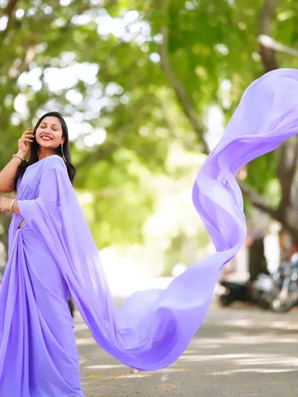 A joyful shot of the lavender trail saree, with the pallu creating a beautiful swirl of color.