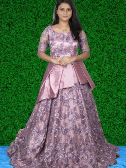 An intricately designed mauve gown with a lace-embroidered skirt and a satin peplum top. This is a highly detailed and luxurious rental option.