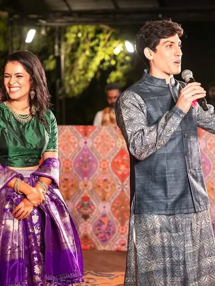 The groom gives a speech at the Sangeet, a heartfelt moment shared with his bride and their guests.