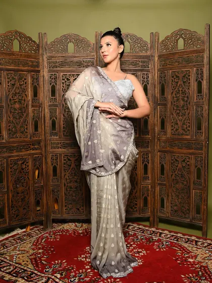 This pose highlights the elegant drape of the saree and the intricate work on the border. It's a perfect shot for a brand catalogue, showing the product with clarity and style.