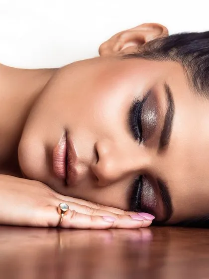 An artistic beauty shot with a serene, peaceful expression. This style of portrait can be used for skincare campaigns or editorials focused on natural beauty.