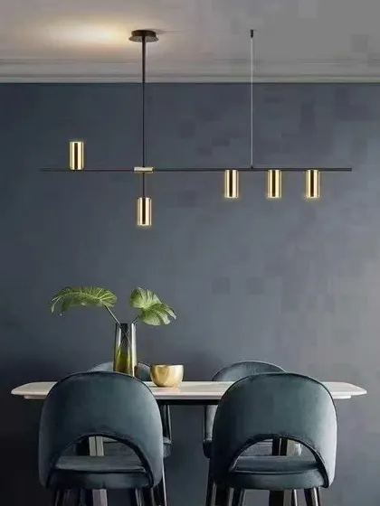 This minimalist black and gold LED chandelier offers a sophisticated lighting solution for modern dining rooms or kitchen islands. The adjustable cylindrical lights allow you to direct focus where it's needed, combining sleek design with practical function.