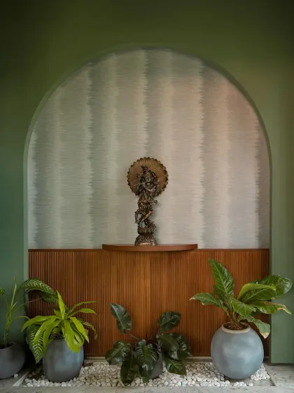 A quiet niche in the foyer houses a Krishna idol, a cherished possession of the clients. This space blends spiritual devotion with my design language of natural materials and soft, ambient lighting.