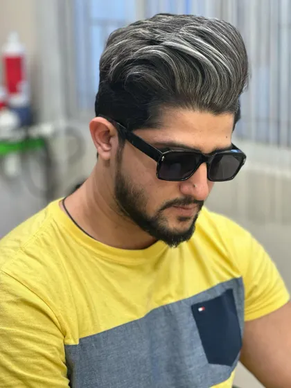 The side profile of this expertly crafted men's silver hair color.
