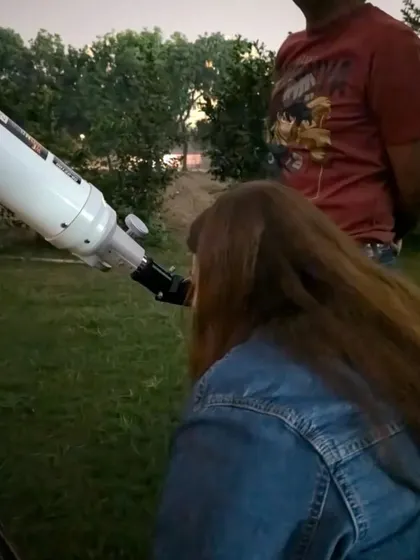 A guest looking through the telescope during dusk at the farm.