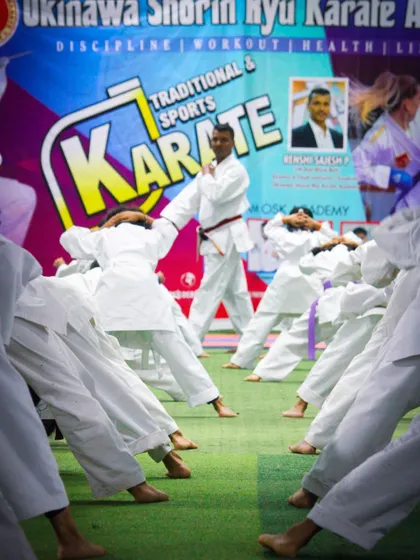 Students perform synchronized warm-ups in front of our academy banner. These group exercises build unity and prepare them mentally and physically for the examination ahead.