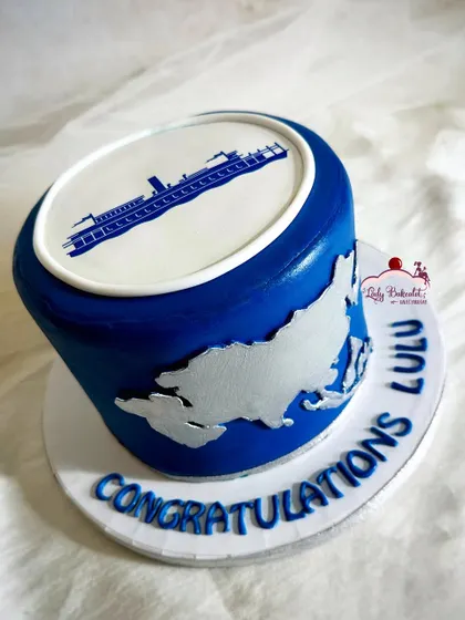 A corporate cake for a promotion celebration, featuring a company logo and a world map.