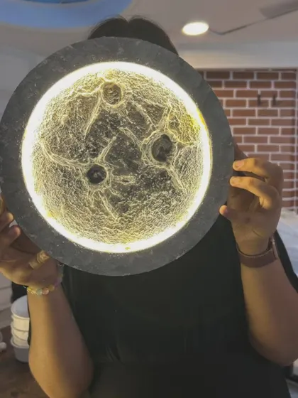 A close up of a finished moon lamp, highlighting the intricate craters and texture that give it a realistic look.