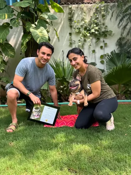 Posing with a proud French Bulldog graduate and his guardian. We work with dogs of all breeds and sizes.