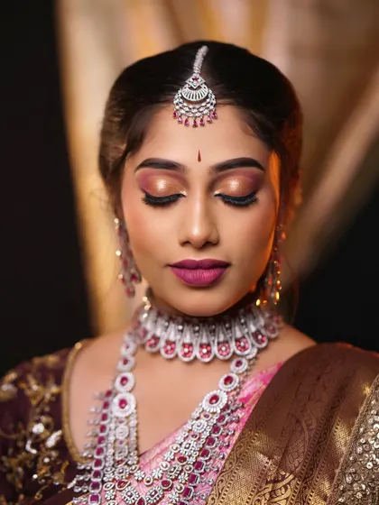 The flawless finish of the makeup is evident in this close-up. The skin looks smooth and radiant, and the eye makeup is perfectly symmetrical.