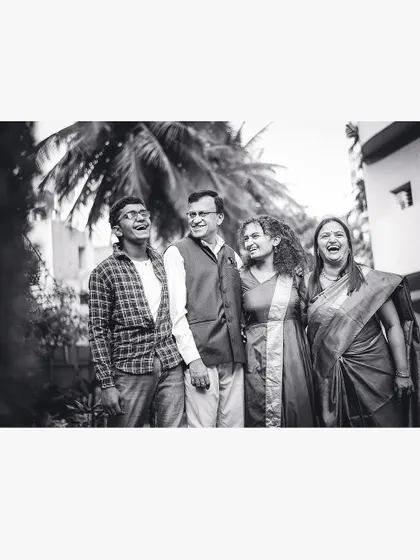 Another angle of a family sharing a laugh, captured in timeless black and white to emphasize the emotion.