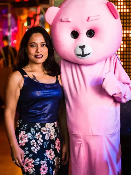 A guest posing with the club's mascot, adding a touch of fun to the night.