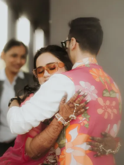 A warm embrace filled with emotion. This soft-focus shot captures the feeling of a heartfelt hug during the Haldi ceremony, a moment of pure connection amidst the celebrations.