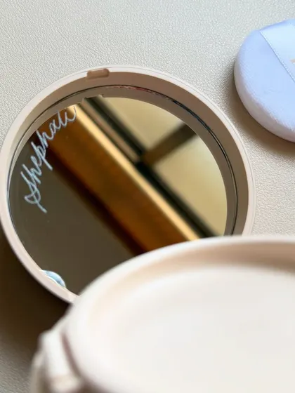 Another view of the engraved Dior compact mirror, showing the final product with the powder puff. It's these small, hidden details that can make a gift truly special.