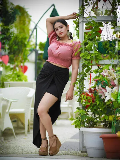 A more dynamic pose from the same shoot, with the model's arm raised, adding energy to the shot.