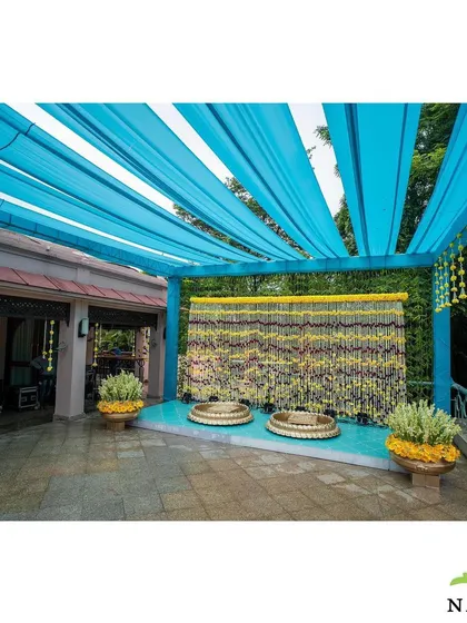 A vibrant Haldi ceremony setup. I used a bright blue canopy to contrast beautifully with the traditional yellow marigold decor, creating a fresh and modern take on the classic Haldi theme.