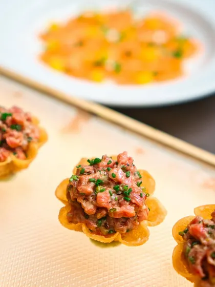 A closer look at the Steak Tartare tarts, showcasing the finely chopped steak and fresh chives. It's a perfect bite-sized appetizer to start your meal.