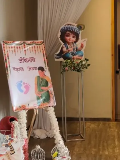 The welcome area for a 'Dohale Jevan' ceremony. It features a welcome sign on an easel and character cutouts, setting a traditional tone for the event.