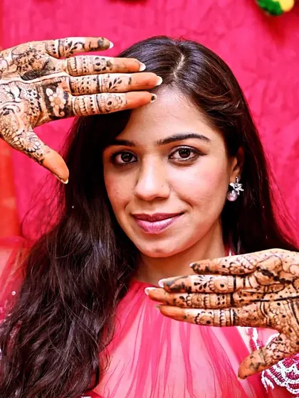 Another lovely portrait of a bride framing her face with her henna-adorned hands.