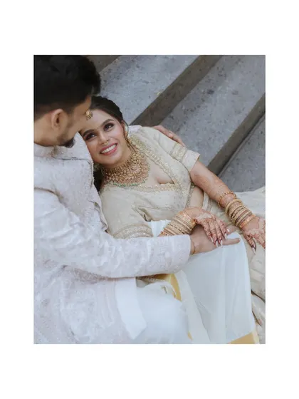 A sweet, intimate portrait of the couple, the bride resting her head on the groom's shoulder.