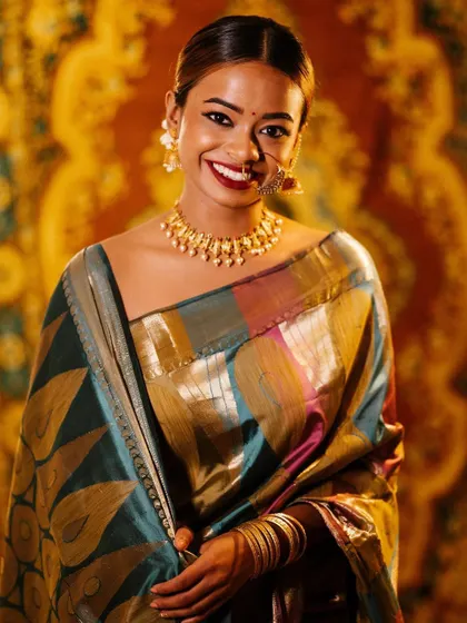 A joyful portrait that captures a bright, genuine smile. The warm lighting and colorful saree create a festive and welcoming feel, perfect for capturing memories of special occasions.