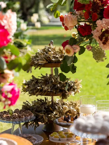 A unique, textured decorative element on a dessert table, surrounded by colorful floral arrangements. These small, artistic details add a layer of sophistication to the event styling.