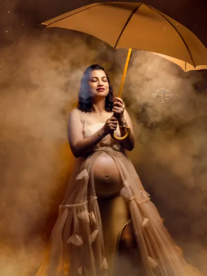 A creative studio shot using an umbrella and atmospheric smoke to create a moody and artistic solo portrait.