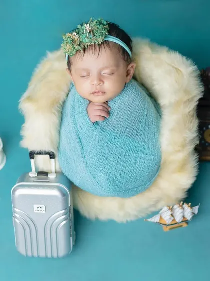Ready for an adventure! This creative setup includes a tiny suitcase for a traveling baby.