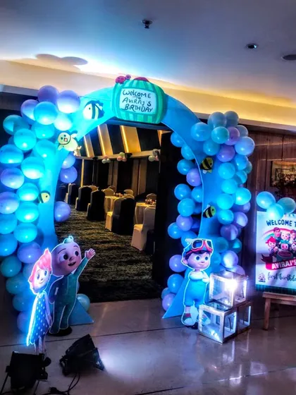 An inviting entrance arch for a Cocomelon themed birthday party. The custom arch and character cutouts welcome guests into the celebration.