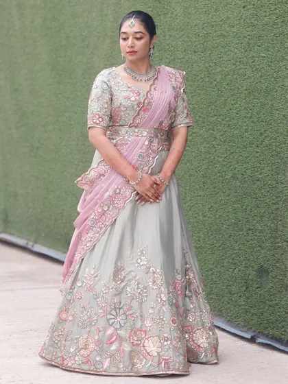 A full view of this unique pastel lehenga look. The draping is modern and elegant, and the makeup is tailored to complement the soft colors of the outfit.