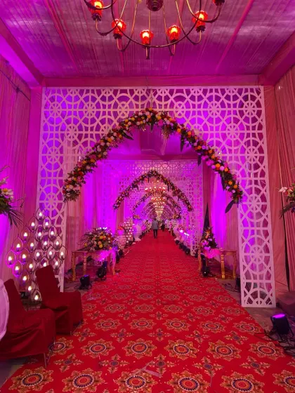An angled view of the lattice archway entrance, showcasing the intricate details of the custom-built panels.