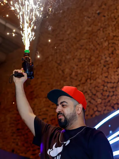 Another angle of the sparkler gun, lighting up the DJ booth and the faces of the crowd.